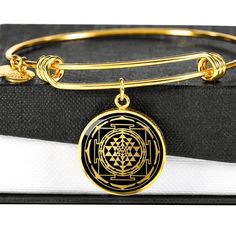 "This Sri Yantra Bracelet Is the Perfect Gift Whether for Yourself or a Loved One. Explore all our sacred geometry jewelry here: https://www.etsy.com/in-en/shop/SymbolicPresent?ref=simple-shop-header-name&listing_id=877238359§ion_id=22613481 ➜ Our jewelry is made of high-quality surgical steel with a shatterproof liquid glass coating and an 18k gold finish option. ➜ Engrave onto the back of the Sri Yantra pendant your loved one's name, your wedding date, an anniversary, or anything else you Symbolic Bracelet Jewelry As Gift, Symbolic Round Bangle For Gifts, Amulet Style Bracelet Jewelry Gift, Spiritual Hypoallergenic Bangle As Gift, Spiritual Bangle Jewelry Gift, Symbolic Gift Bangle, Amulet Bracelet Jewelry As Gift, Gold Amulet Bracelets As Gift, Adjustable Engraved Spiritual Bangle