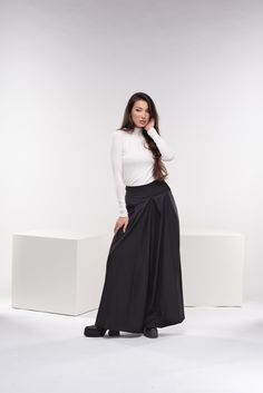 "Absolutely gorgeous wide-leg palazzo pants with a zipper on the back as closure, and two side functional deep pockets for your comfort. These wool trousers have that gorgeous, inspiring, breathtaking, chic, classic but still modern look. The fabric is super soft high-quality cold wool fabric. You can find the short version here: https://www.etsy.com/listing/1298365794/wool-wide-leg-pants-palazzo-skirt-pants?ref=listings_manager_grid ◼ FIT These palazzo skirt pants are of regular fit. To have the same look as on our model, please check our body measurements size chart below, especially the waist measurement, and choose the correct size for you. ◾The model in the picture is wearing size XS in black color. ◼ FABRIC ◾cold wool mix fabric ◼ INFO: ◾ Worldwide express shipping - please provide a Fall Evening Wide Leg Maxi Skirt, Wide Leg Black Maxi Skirt For Work, Black Loose Fit Wide Leg Maxi Skirt, Black Wide-leg Maxi Skirt, Black Stretch Wide Leg Maxi Skirt, Baggy Wide Leg Maxi Skirt For Fall, Palazzo Pants Winter, Wide Leg Trousers Plus Size, Palazzo Skirt