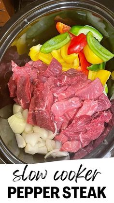 slow cooker pepper steak served in a pot with onions, peppers and celery