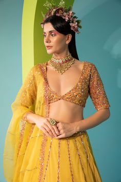 Yellow tulle lehenga with mirror, zari sequin embroidery. Comes with embroidered blouse and dupatta.
Component: 3
Pattern: Embroidered
Type Of Work: Mirror Work
Neckline: Plunged V-Neck
Sleeve Type: Half
Fabric: Tulle, Organza, Lining: Cotton Shantoon
Color: Yellow
Other Details: 
Back cut-out with tie-up
Sheer dupatta with embroidered borders
Occasion: Mehendi and Haldi - Aza Fashions Tulle Lehenga, V Neck Lehenga, Yellow Mirror, Sheer Dupatta, Embroidered Lehenga, Sequin Embroidery, Sequins Embroidery, Mirror Work, Embroidered Blouse