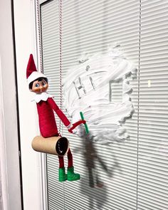 an elf hanging on the side of a door