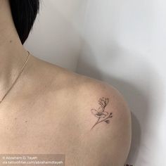 a woman with a flower tattoo on her shoulder