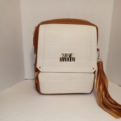 Steve Madden Backpack Cream & Brown Monogram Straps Walk With Style 11.5x10.25x4 Cream Rectangular Backpack For Everyday Use, Rectangular Cream Backpack For Everyday Use, Cream Rectangular Backpack For Daily Use, Everyday Use Cream Rectangular Backpack, White Rectangular Leather Backpack For School, White Leather Rectangular Backpack For Everyday Use, Trendy Cream Rectangular Backpack, White Crossbody Travel Backpack, White Crossbody Backpack For Daily Use