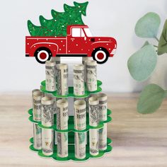 a red truck with a christmas tree on top of it and stacks of twenty dollar bills