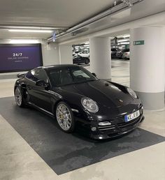 a black sports car parked in a parking garage