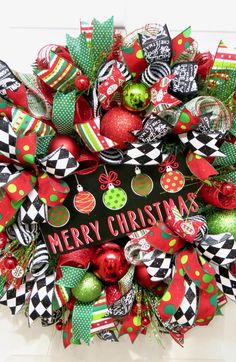 a christmas wreath with red, green and black decorations