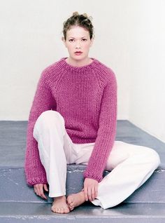 a woman sitting on top of a mattress