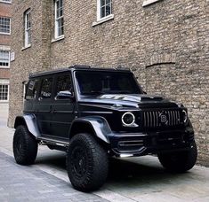 a black jeep parked in front of a brick building