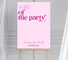 a pink sign with the words wife of the party on it in front of curtains