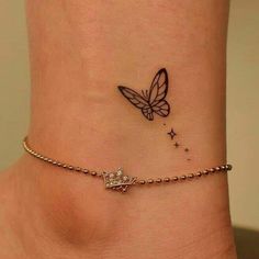 a small tattoo on the ankle of a woman's foot with a butterfly and stars