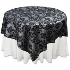 a black and white table cloth on top of a round table