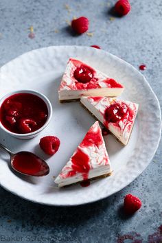 three slices of cheesecake with raspberry sauce on a plate next to it