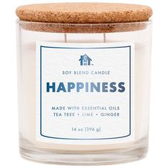 a candle with a cork lid that says happiness made with essential oils and tea tree