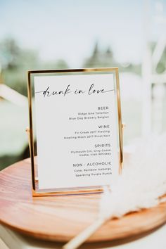 a close up of a menu on a wooden table with a white and gold plate