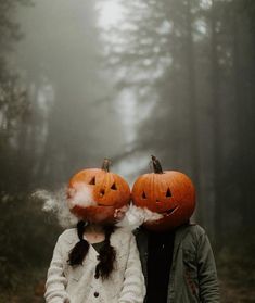 two people with pumpkins on their heads