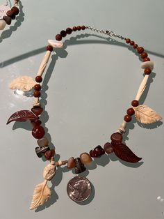 "This jasper and fossil bead necklace includes clay beads, sterling replica frogs from Peru, bone, mother of pearl and has a sterling silver chain and lobster claw clasp. When we had an open house for the archaeology finds at Trunk Bay, I designed a group of necklaces that were inspired by the Taino Indians who lived on St John.  They used croton leaves in head dresses and small beads carved from bone and shell.  There are also two fire opal beads from Mexico and old carnelian agate beads.  The Pearl And Jasper Necklace, Jasper Necklace, Agate Beads, Star Pendant, Clay Beads, Fire Opal, Chain Styles, Fossil, Sterling Silver Chains