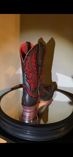 The Ariat® Tailgate cowgirl boots feature distressed leather, metallic finishes, and bold colors, making them ideal for wearing with skinny jeans, leggings, and dresses. This pair is blinged out with 9,000 red and black Swarovski crystals. Size 8 Premium full grain leather upper. Classic Western cowgirl boot with side leather pull loops for easy entry. Features unique Western-inspired stitch pattern on shaft and foot. Inside zipper for easy on and off. Leather lining for a comfortable fit. 4LR™ Cowgirl Boots Square Toed, Western Shoes, Cowgirl Boot, Jeans Leggings, Western Cowgirl, Western Cowboy Boots, Leather Pulls, Distressed Leather, And Dresses