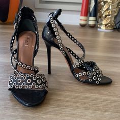 - Designer = Alaia Paris - Size =6.5m(36.5). Trunk 57 - Msrp = $1370 - Alaia Paris Perforated Leather 6.5m Made In Italy Open Toe Strappy Sandals - Heel Height = 4.25” Inches (10.5cm) - Metal Studded Black Leather - Measured On The Inside From Front Tip Of Open Toe To Back Tip Of Heel To Give An Estimate Of Size Length = Approximately 24cm -: This Is Mannequin Display Item. Never Worn. Only Tried On In The Store By Customers. - Genuine And Authentic Or Your Money Back Trunk 57 Formal Ankle Strap Sandals With Studded Rubber Outsoles, Luxury High Heel Sandals With Studded Outsoles, Designer Heels With Ankle Strap And Studded Outsoles, Party Sandals With Studded Rubber Outsoles And Ankle Strap, Evening Sandals With Studded Rubber Outsoles And Open Heel, Leather Sandals With Studded Rubber Outsoles For Night Out, Elegant Ankle Strap Heels With Studded Rubber Outsoles, Formal Open Toe Heels With Studded Rubber Outsoles, Chic Leather Heels With Perforations