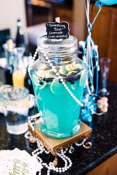 a table topped with a jar filled with blue liquid