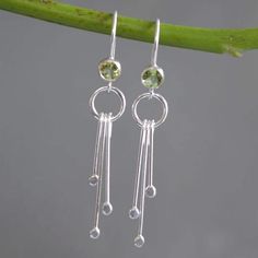 "Elegant sterling silver earrings featuring a natural faceted green peridot and cascading dangles. The back of the bezel is open allowing light to pass through the gemstone. The earrings have been polished to a bright and shiny finish.  Peridot is the birthstone for August and is the traditional 16th wedding anniversary gift. Peridot is associated with harmony, good health and peacefulness.  These lovely earrings would make a wonderful gift for yourself or your loved one. Perfect for weddings, bridesmaids gifts, birthday gifts or just a special day out. Comfortable and suitable for everyday wear.  Dimensions: The total length of the earrings: 4.5 cm (1.7\") Width : 7 mm at the widest point. Peridot: 4 mm Materials: Peridot 925 sterling silver Metal: 925 sterling silver These gorgeous semi- Peridot Dangle Earrings With Ear Wire, Silver Peridot Drop Earrings, Peridot Gemstone Dangle Earrings, Silver Peridot Dangle Earrings, Silver Dangle Peridot Earrings, Dangle Peridot Gemstone Earrings, 16th Wedding Anniversary, August Birthday, Peridot Earrings