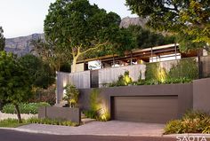 a modern house with trees and plants on the roof