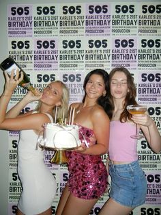 three beautiful young women standing next to each other holding drinks and cake in their hands