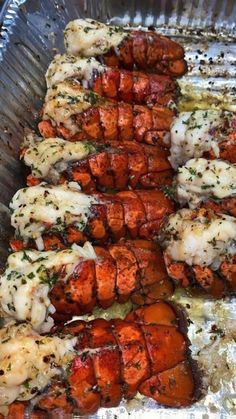 some cooked lobsters are sitting in a pan