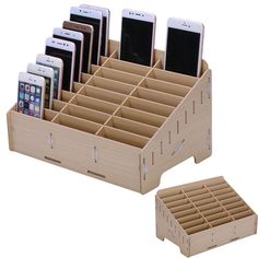 several cell phones are sitting in a wooden holder with compartments on each side and one is open