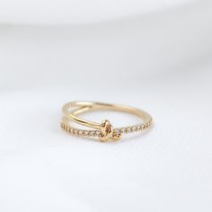 This eye-catching ring features a pavé band hugged by a knot. The knot ring is timeless and meaningful. Symbolizing love and friendship, this reminder ring makes a beautiful gift.  - Main material: 14k Gold, Rhodium, Rose Gold Plated on Brass, Cubic Zirconia - Handmade Need some jewelry inspiration? Follow us on Instagram  @statementGrey Knot Diamond Ring, Diamond Knot Ring, Cute Promise Rings, Gold Ideas, Gold Knot Ring, Dream Rings, Diamond Knot, Ring Inspo, Love Knot Ring