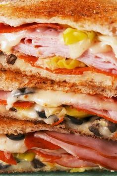 a close up of a sandwich with meat and cheese