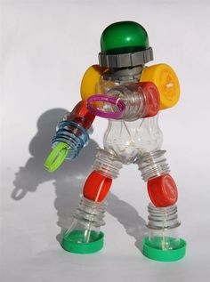 a plastic toy robot holding a green and yellow object