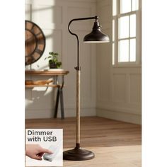 a lamp that is on top of a wooden floor next to a poster with the words dimmer with usb