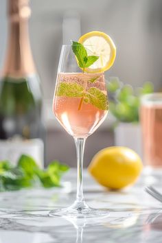 a glass filled with pink wine and lemon