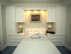 a white bed sitting in a bedroom next to two nightstands