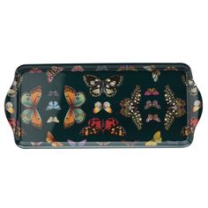 a black tray with butterflies on it