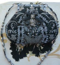 "An exquisite vintage Mary Frances shoulder bag with beautiful black uneven tassels. This stunning handbag includes striking gray/black fabric with lovely multi-colored beads and lace. It comes with elegant silver hardware. Its interior is lined with lovely black silk-like fabric. The bag has the \"Mary Frances\" gold metal ID tag on its outside and a \"Mary Frances\" fabric logo inside. It is in great condition. Perfect for Mary Frances collectors and lovers of exquisite hand-crafted designer b Elegant Handmade Bags For Festival, Bohemian Evening Bags With Beaded Fringe, Handmade Bohemian Shoulder Bag For Evening, Elegant Rectangular Shoulder Bag For Festivals, Bohemian Black Shoulder Bag For Evening, Evening Bohemian Handmade Shoulder Bag, Elegant Formal Shoulder Bag With Tassels, Bohemian Evening Bag With Beaded Fringe, Elegant Beaded Bags For Festival