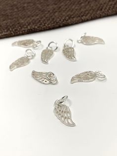 925 Sterling Silver Angel Wing Charm Approx. Size: 18mm x 6mm ( including jump ring) Approx. Inner Jump Ring: 4mm Color: Silver Material: 925 Sterling Silver Quantity: 1pc  Shipping Details: ♥ FREE SHIPPING to Canada via Canada Post for all orders above CA$100. Any orders above CA$50 will have a tracking number as well ♥ FREE SHIPPING to USA for all orders above US$35 via USPS First Class Mail Tracked. CA$8.99 Delivery charges for orders below US$35 ♥ All orders are shipped within 1-2 business d Elegant Sterling Silver Charms For Jewelry Making, Sterling Silver Charms With Lobster Clasp, White Gold Sterling Silver Charms, Hallmarked, Engraved Sterling Silver Charms In Silver, Hypoallergenic Silver Charms For Anniversary, Sterling Silver Pendant Charm In Silver, Silver Engraved Charms For Jewelry Making, Silver Sterling Silver Pendant Charm, Silver Charms With Lobster Clasp For Jewelry Making