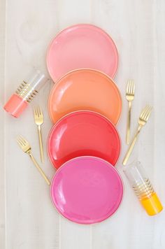 colorful plates and utensils on a white surface