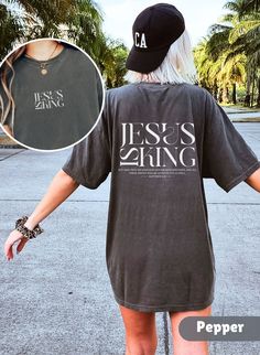 Introducing the Bible Verse T-shirt Jesus is King, a must-have for anyone seeking to spread the message of faith in style! This Comfort Colors Christian Shirt Crewneck makes the perfect Christian Gift for friends, family, or yourself. Runs true to size but size up if you would like a more oversized fit. Please check photo cards for detailed size guide. Comfort Colors®1717 is a made 100% with US cotton for long-lasting comfort. The soft-washed, garment-dyed fabric brings extra coziness to your wardrobe while the relaxed fit makes it an excellent daily choice.  Our designs are printed using the highest quality professional direct-to-garment (DTG) process, meaning fabric-grade ink is printed directly onto the garment and seamlessly blends with the fibres. This method enables us to achieve a v Christian Gift Shop, Christian Shirts Designs, Jesus Is King, Church Shirt, Bible Verse Shirt, King Shirt, King Tshirt, Jesus Shirt, Christian Sweatshirt