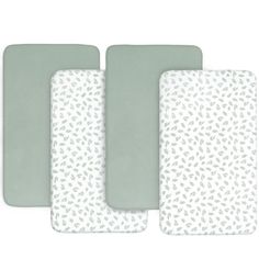 three placemats with white and green leaves on the front, one in grey