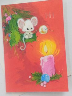 a greeting card with a candle and a mouse on it