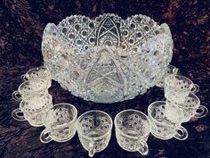 an ornate glass bowl and six matching cups