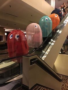 people are riding an escalator with hats on them in the airport or shopping center