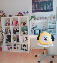 a chair with a stuffed animal on top of it in front of a book shelf