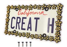 a california license plate with screws on the front and bottom, which reads'create h '