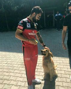 a man is petting a dog on the street