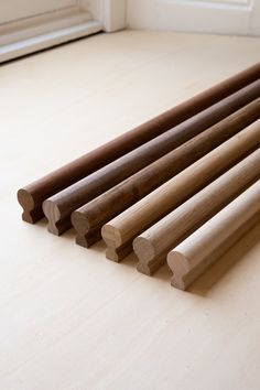 several wooden dowks are lined up on the floor in front of a white door