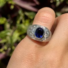 Estate/ vintage 14KT white gold oval-cut, synthetic, dark blue sapphire + gypsey-set diamond domed ring. Size 4.75 Can be resized for an additional fee Weight: 7.30 grams (10) natural, round diamonds SI/1, G Color diamonds Gypsy-set diamonds Sapphire: synthetic sapphire measures approx.: 8mm x 6mm Oval-cut, Dark Navy blue, Faceted sapphire Brushed Matte Finish Excellent estate condition Sapphire Diamond Ring, Domed Ring, Dark Navy Blue, Sapphire Diamond, Matte Gold, Dark Navy, Oval Cut, Colored Diamonds, Blue Sapphire