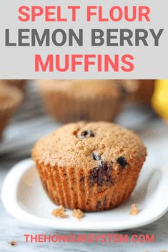 a muffin on a plate with the words lemon berry speltt flour muffins