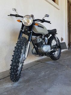 a motorcycle is parked in front of a building with no one on it's bike